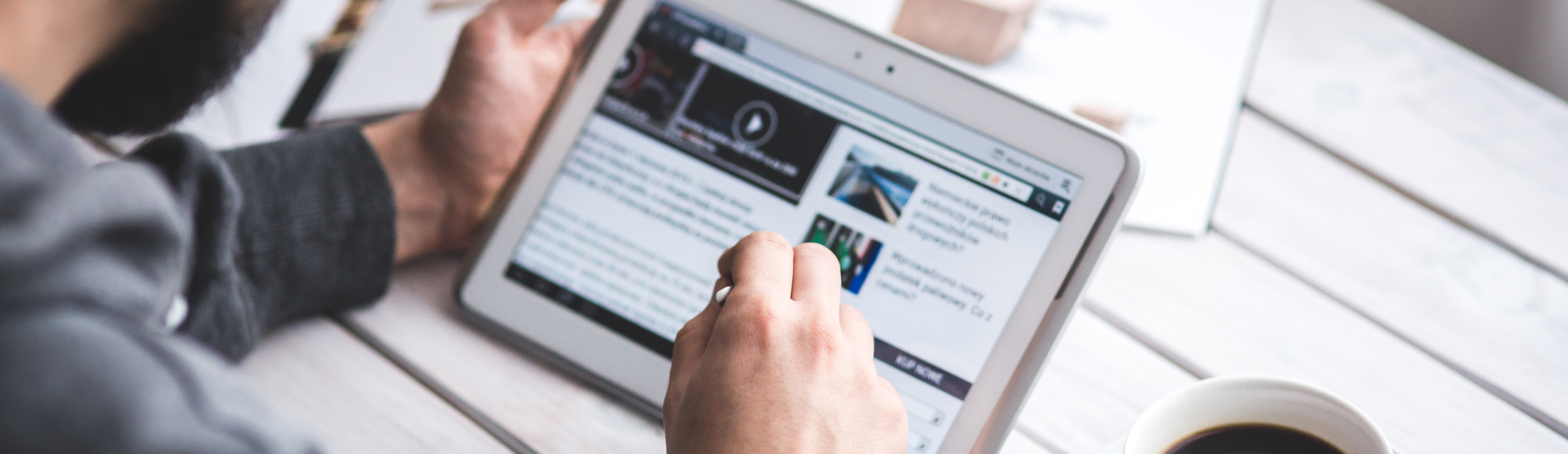 Person using tablet to read digital content, representing online information access
