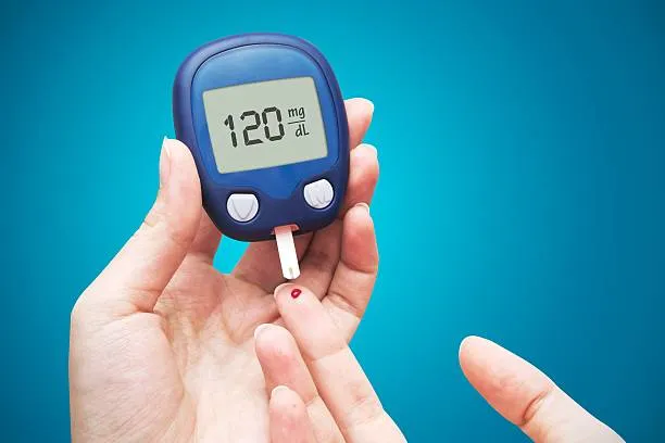 Person checking blood sugar with glucose meter, indicating diabetes management
