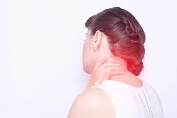 Woman holding neck with red pain highlight, indicating fibromyalgia discomfort
