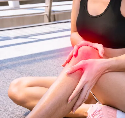 Woman holding painful knee with red highlight, indicating inflammation markers
