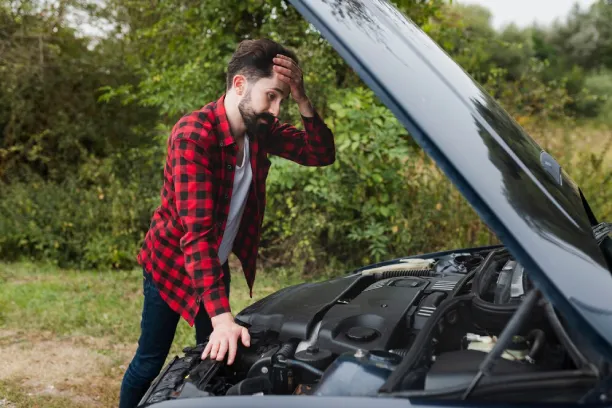 Man looking stressed with car hood open, showing vehicle trouble and frustration
