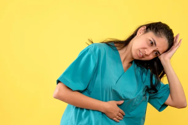 Woman holding stomach and head, showing nausea, dizziness, or digestive discomfort
