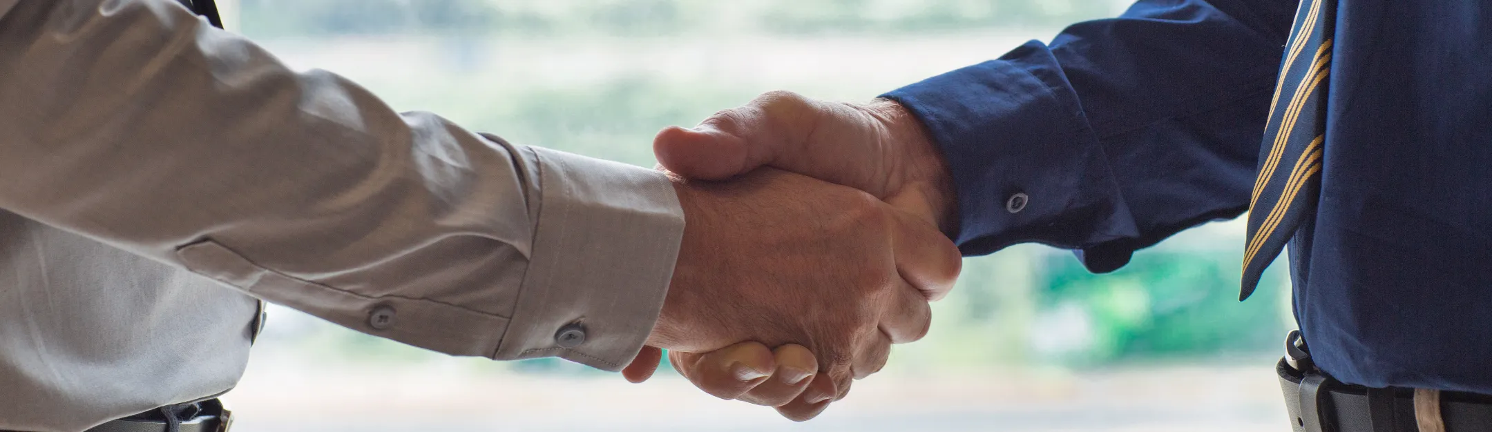Business handshake symbolizing partnership, trust, and professional collaboration
    