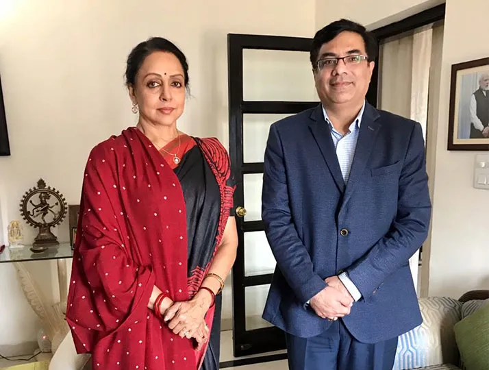 Client testimonial graphic featuring Mrs. Hema Malini with a healthcare professional indoors